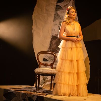 performer on raised stage in yellow dress